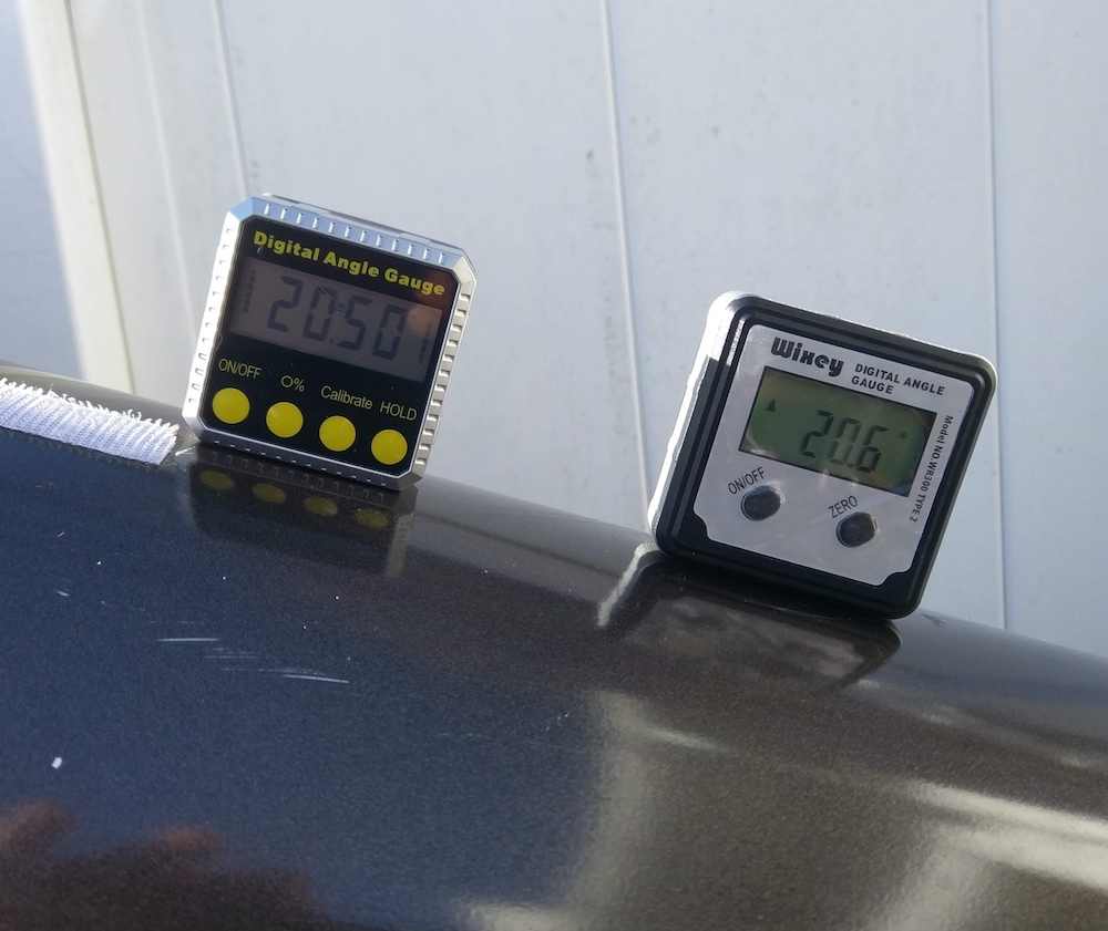 Digital angle gauges placed on the top of an optical tube of a telescope