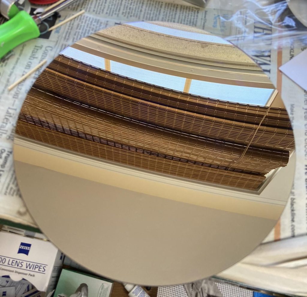 A newtonian reflector telescope's primary mirror taken out