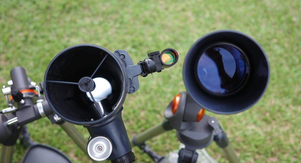 a reflector and a refractor front lens/mirror element close up